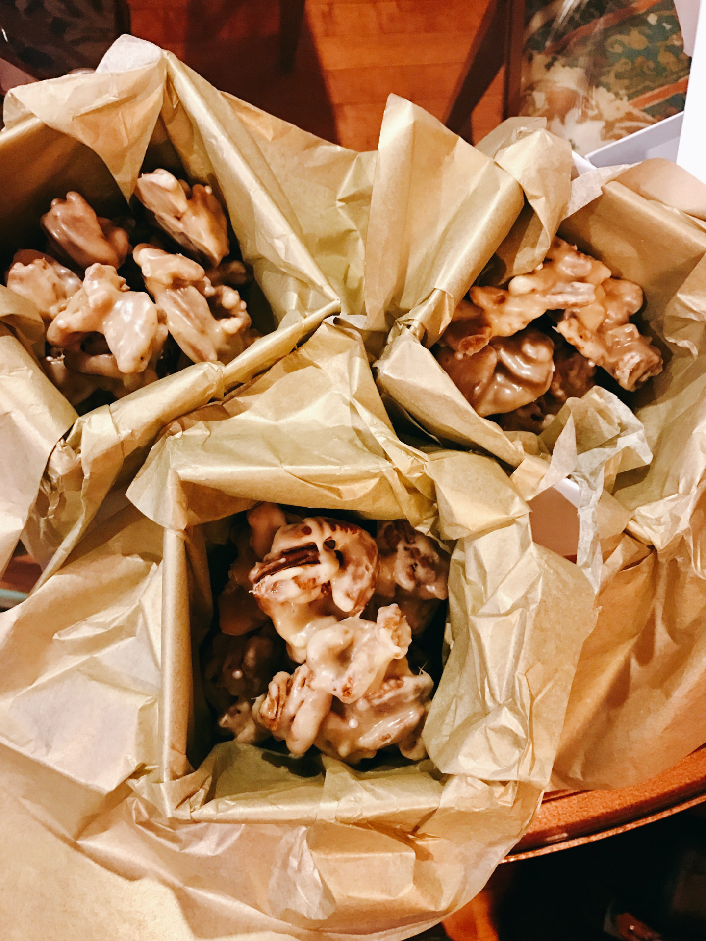 Homemade pralines wrapped in gold tissue paper, ready to gift