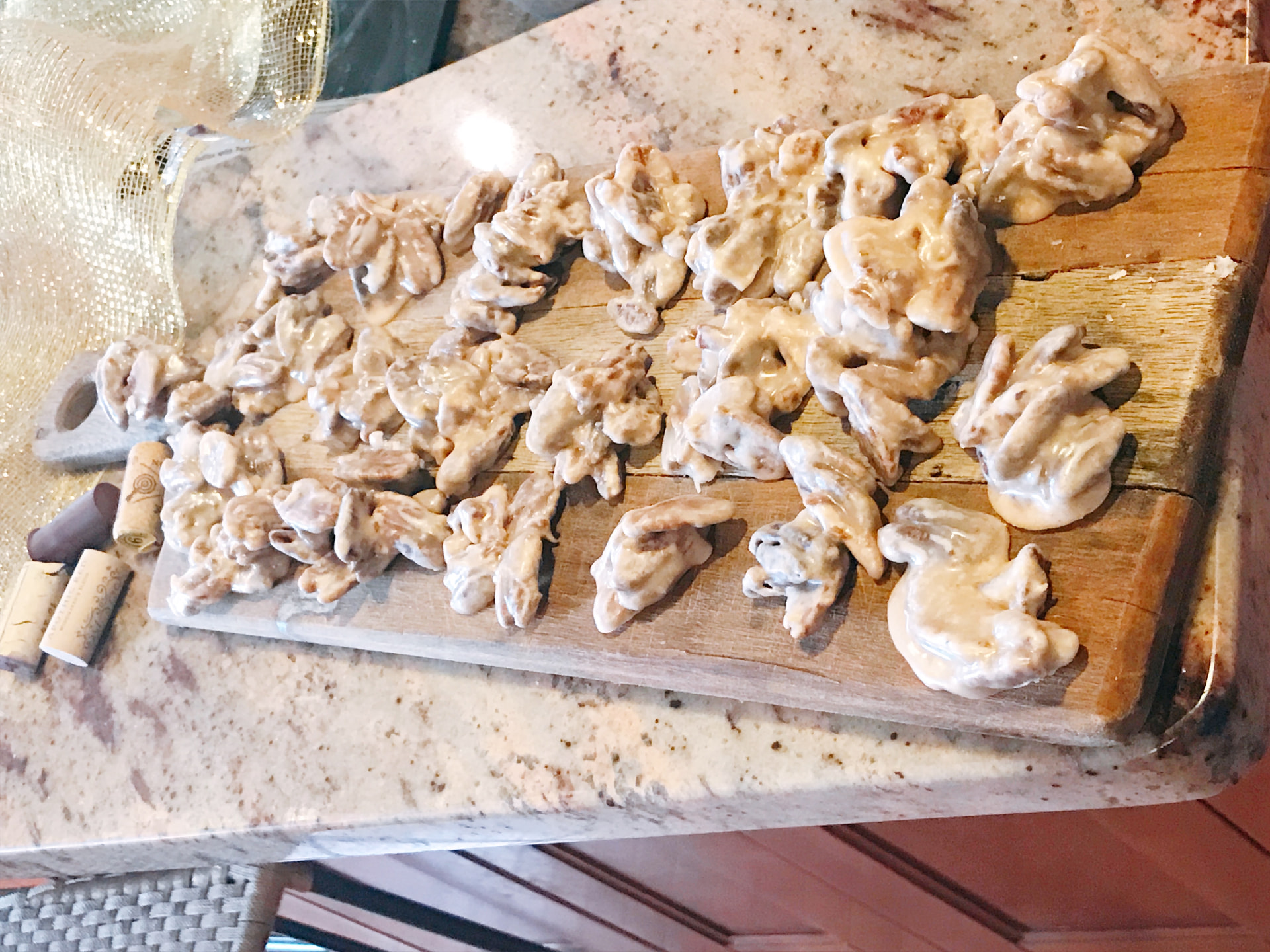 Homemade pecan praline clusters on a wooden board