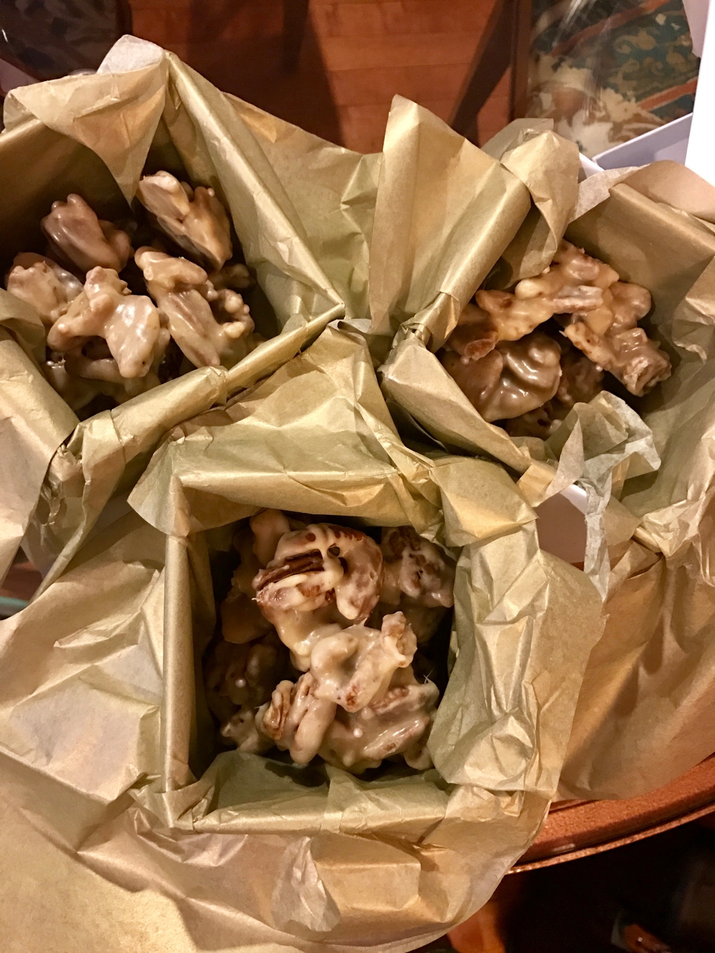 Homemade pralines wrapped in gold tissue paper, ready to gift